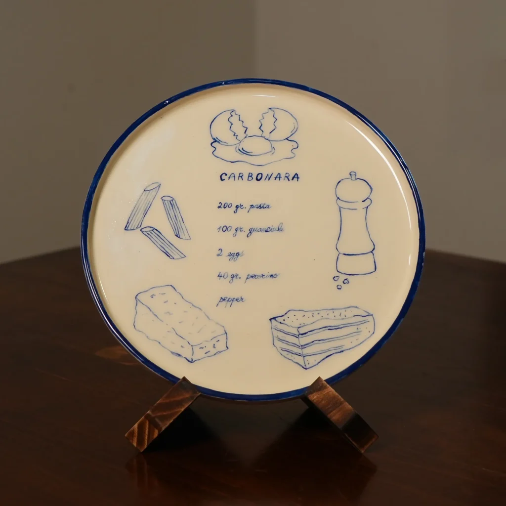 Hand-painted Carbonara plate displayed on its stand, by Franci Pots